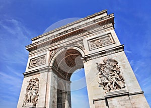 The ornate Arce de Triomphe against a blue sky, Paris, France photo