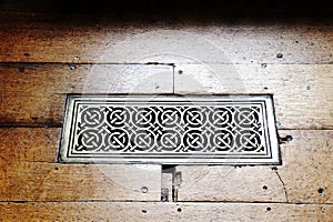 Ornate brass floor heating grill