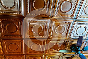 Ornate Bronze Tin Ceiling Tiles with Ceiling Fan in Vintage Interior