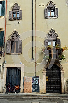 Ornate building with bicycle parked outside Verona, Italy