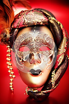 Ornate carnival mask over red background