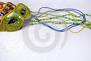Ornate carnival masks, multicolor beads on white background. Mardi gras festive banner