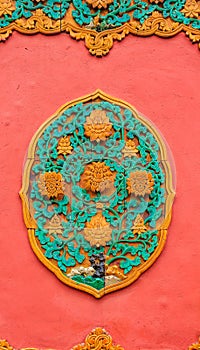 Ornate ceramic ornament on the wall in the Forbidden City of Beijing China