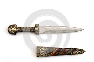 Ornate ceremonial dagger next to a jeweled scabbard