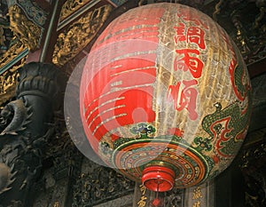 Ornate Chinese Temple lantern hanging from a temple ceiling