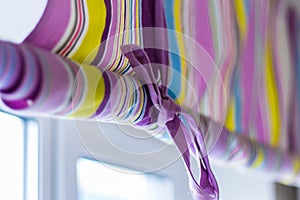 Ornate colourful curtain with lines covering the whole window
