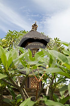 Ornate decorated spirit house with thatched roof in Bali,Indonesia