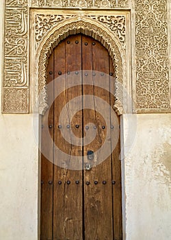 Ornate Door Frame and Ancient Wooden Door at Alhambra