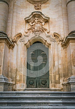 Ornate door to the Duomo of San Giorgio in Modica, fine example of sicilian baroque art. Sicily, southern Italy.