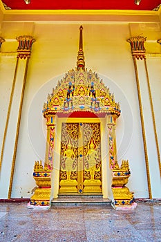 The ornate door of Ubosot, Wat Suwan Kuha Cave Temple, Phang Nga, Thailand