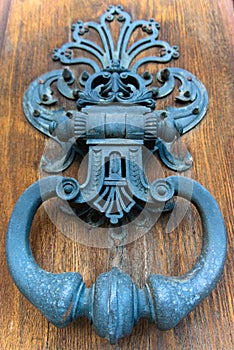 Ornate doorknocker on wooden door