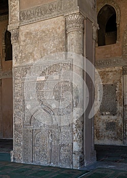 Stone wall with engraved floral patterns and calligraphy in front of the foundation stone of Ahmed Ibn Tulun Mosque, Cairo, Egypt