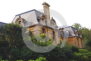 Ornate facade with arched dormer windows and chimney