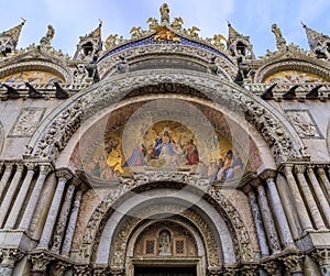 Ornate facade of Saint Mark`s Basilica with mosaics on Saint Mark`s square in Venice Italy