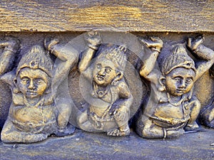 Ornate figures of tiny beings on temple wall, Tissamaharama, Sri Lank