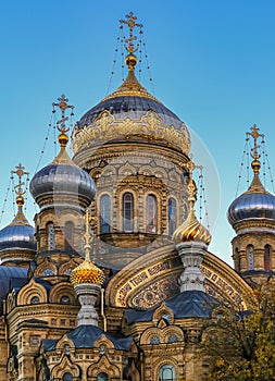 Ornate golden domes and crosses of the Russian Orthodox Church of the Assumption of Mary in Saint Petersburg Russia