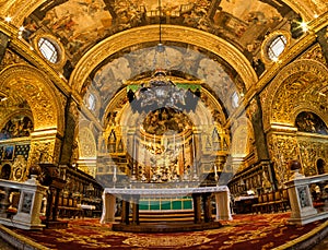 Ornate golden interior of St. John`s Co-Cathedral. Valletta, Malta