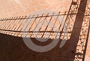 Tile floor and iron fence shadow