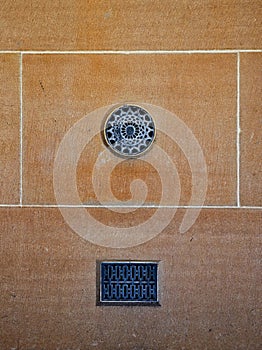 Ornate Metal Vents on Old textured sandstone Block Wall, Sydney, Australia