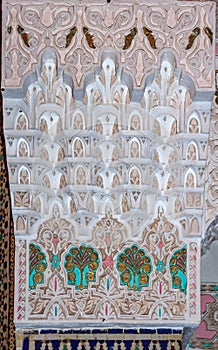 Ornate Moroccan plaster arabesque carving on a wall in a riad