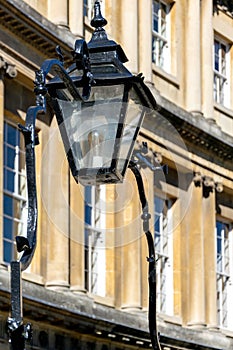 Ornate overthrow and lamp attached to the railings on The Circus, Bath