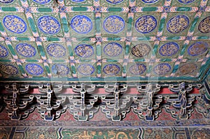 An ornate painted ceiling on a building in the Forbidden City in Beijing