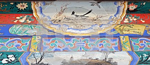 An ornate painted ceiling on a building in the Forbidden City in Beijing