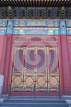 An ornate painted door on a building in the Forbidden City in Beijing