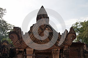 Ornate pediment above doorway at 10th century Banteay Srei temple