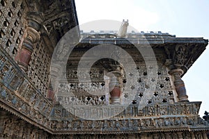 Ornate perforated window and Madanikas, Salabhanjika meaning celestial damsels, on top of the pillars. Chennakeshava temple, Belur