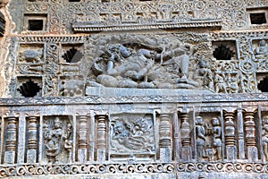 Ornate perforated window. A sculpture of Sheshashayee Vishnu with his consort, Lakshmi. Chennakeshava temple, Belur, Karnataka.