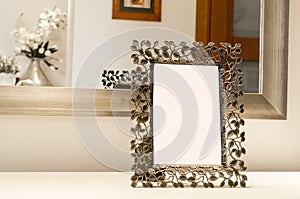 Ornate picture frame on the white table Reflection in Mirror Blank White Isolated Clipping Path
