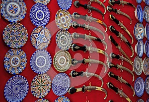 Ornate plates and knives in a souvenir shop at the market in Fes Morocco
