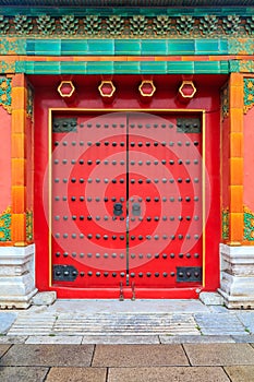 Ornate red wooden door with tile trim and traditional Chinise de