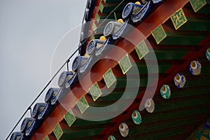 Ornate roof of Chinese temple - red, blue and green rafters with eyes