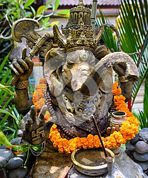 An ornate statue of Ganesha with a swastika on his hand 2