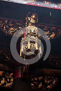 Ornate statue and roof at the Longshan Temple