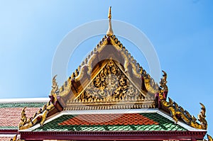 Ornate Temple roof against a dark blue sky at Grand Palace, Thailand