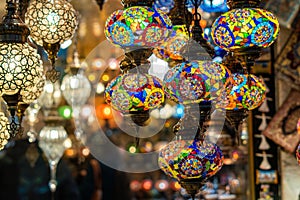 Ornate and vibrant collection of Turkish lamps hanging in front of a market