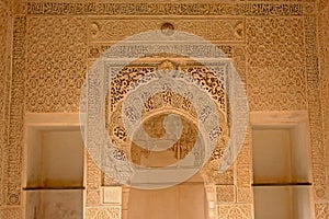 Ornate wall with horse shoe arch of Nasrid Palace , Alhambra, Spain