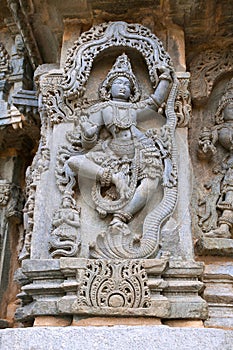Ornate wall panel reliefs depicting Krishna dancing on the head of serpant Kalia and eventually killing him. Kedareshwara temple,