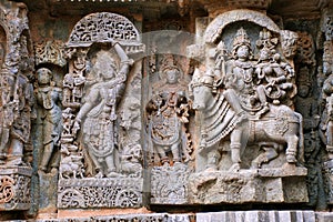 Ornate wall panel reliefs depicting From left Krishna as Govardhan Giridhari and Shiva-Parvati seated on Nandi, Kedareshwara templ