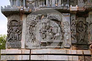Ornate wall panel reliefs depicting From left Varaha, Kamdev and his wife Rati, and dancing Ganesha. Kedareshwara temple, Halebidu