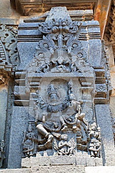 Ornate wall panel reliefs depicting Lord Vishnu with his consort Lakshmi sitting in his lap, Chennakesava temple, Belur, Karnataka