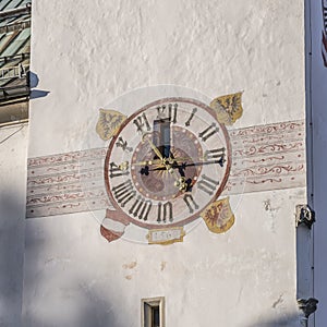 Ornated wall clock at st. Osvald parrish church bell tower, Seefeld, Austria