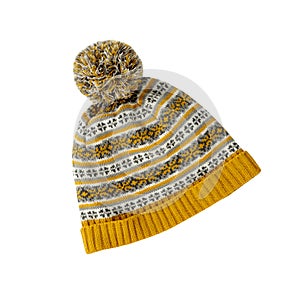 Ornated winter yellow knitted hat with pompom isolated on white background