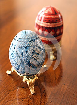 Ornately Decorated Blue and Red Pysanky Ukrainian Easter Eggs on a Gold Stand
