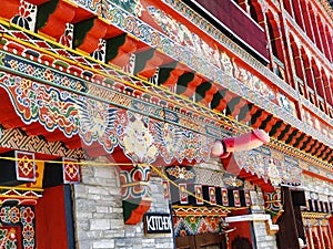 Ornately Decorated Building in Downtown Bhutan with Phallic fertility symbol photo