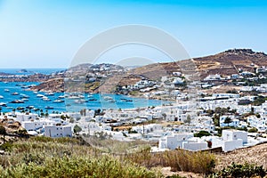 Ornos Beach in Mykonos Greece blue sea, umbrella and luxury beach chairs beds