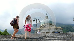 OROPA, BIELLA, ITALY - JULY 7, 2018: two women walk upstairs to Shrine of Oropa, Sanctuary, Sacro monte della beata